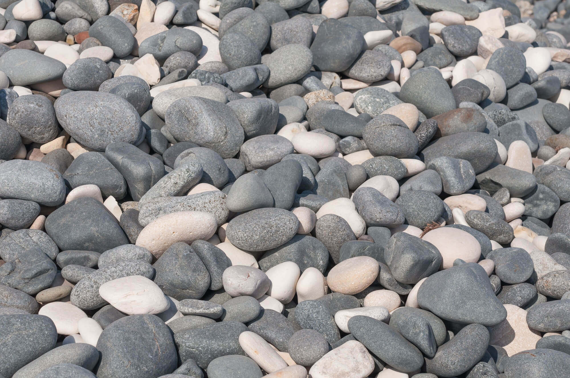 Grey and White stones / Beach stone on grey and white Grey and White stones / Beach stone on grey and white
